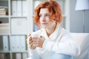 woman drinking tea and feeling anxious