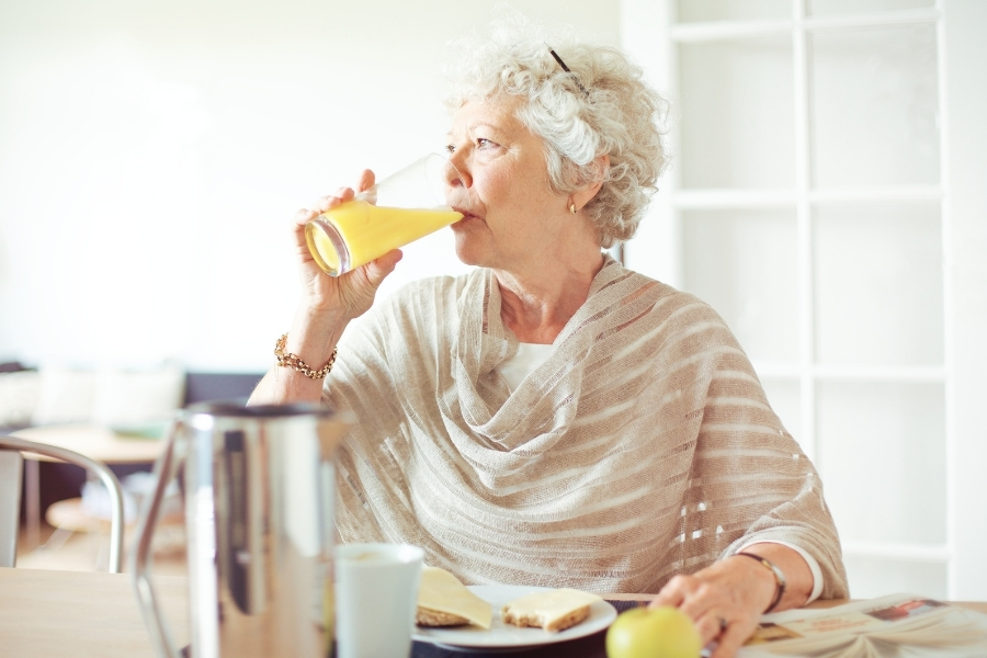Elderly Woman Drinking Juice